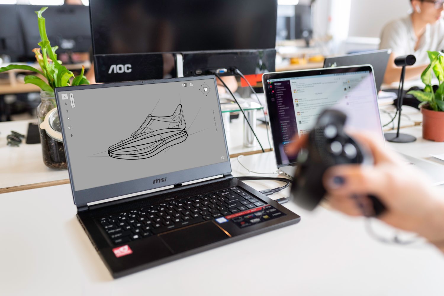 A person designs a 3D model on a computer.