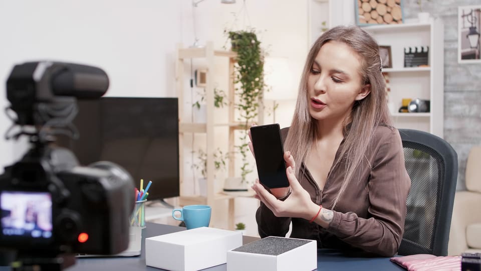A woman films a product video.
