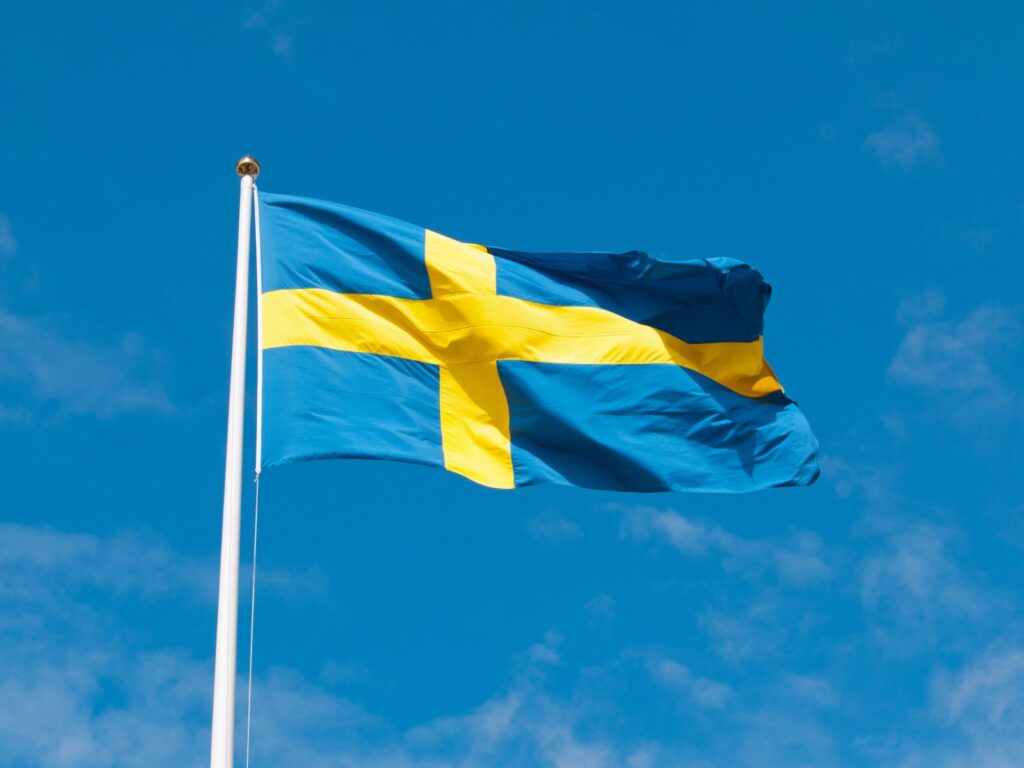 The Swedish flag flies on top of the Swedish parliament, which transcribed the European Accessibility Act in Sweden. 